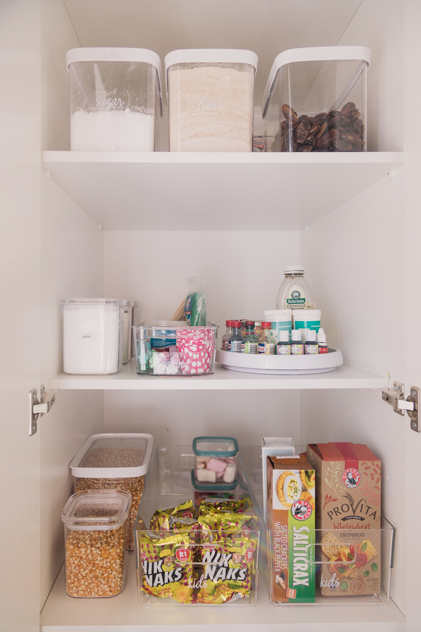 This is the after for a Sorted snacks and baking pantry cupboard
